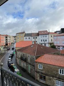 a view from a balcony of a city with buildings at Pensión Arenas Palas in Palas de Rei