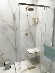 a shower with a glass door in a bathroom at Privately Owned Apartment at Ocean View Villas in Port Edward +25 photos