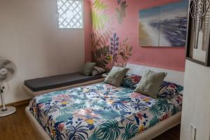 a bedroom with a bed and a bench in it at King's Apartments 301 in Cartagena de Indias