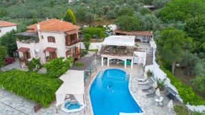 an aerial view of a house with a swimming pool at Seralis Pelion in Afissos