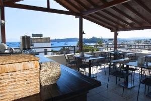 a restaurant with tables and chairs on a roof at Bodrum Smart City Hotel in Bodrum City