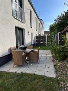 a patio with a table and chairs in a yard at Family Apart nähe Nürnberg in Schwaig bei Nürnberg