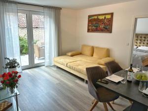 a living room with a couch and a table at Family Apart nähe Nürnberg in Schwaig bei Nürnberg