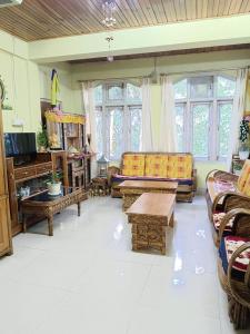 a living room with couches and a piano at Anna homestay in Dirang Dzong