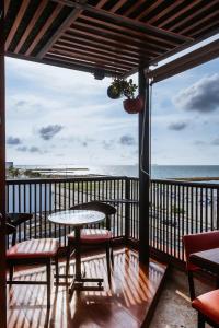 a balcony with a table and chairs and the ocean at King's Apartments 202 in Cartagena de Indias