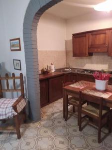 una cocina con mesa y un arco en una habitación en Casa Totti, 