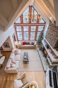 an overhead view of a living room with a large window at Ski In/Ski Out Luxury Tremblant Chalet in Mont-Tremblant