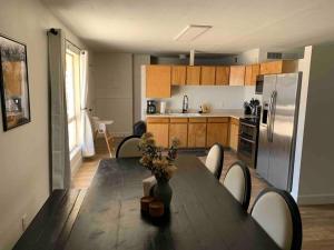 a kitchen with a table with chairs and a refrigerator at Emerald Lake House *Boat Parking with a View in Page