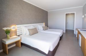 a hotel room with two beds and a sink at Arribas Sintra Hotel in Sintra