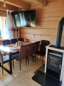 a dining room with a table and a wood stove at Domek Pod Tatrami Kościelisko in Kościelisko