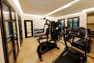 a gym with treadmills and ellipticals in a room at Casa Nostra Boutique Hotel & Spa in Palermo