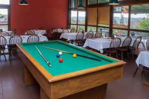 a pool table in a restaurant with tables and chairs at Penzion Hájenka 