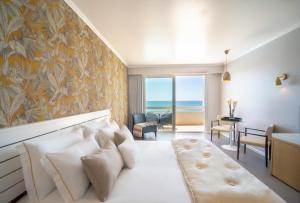 a hotel room with a bed with a view of the ocean at Arribas Sintra Hotel in Sintra