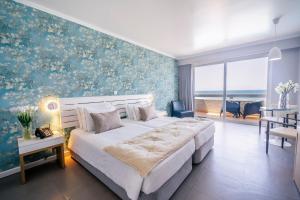 a bedroom with a large bed with a blue wall at Arribas Sintra Hotel in Sintra