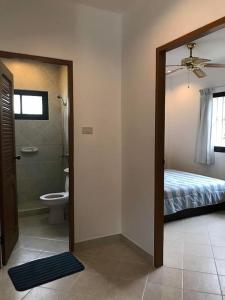 a bathroom with a toilet and a bed and a mirror at Detached 3 bed Villa, private pool - Nirvana Pool Villa 2 in Nong Prue