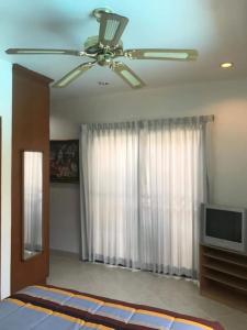 a bedroom with a ceiling fan and a television at Detached 3 bed Villa, private pool - Nirvana Pool Villa 2 in Nong Prue +53 photos