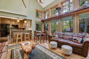 a living room with a couch and a table at 734 Disciples Village Condo in Boyne Falls