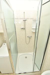 a shower with a glass door in a bathroom at Appartamenti Arcobaleno in Casa Bullo