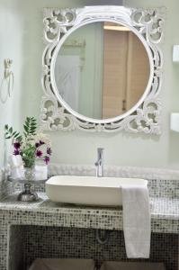 a bathroom with a sink and a mirror at Villa Mon Rêve "5-minute walk beach, restaurants, supermarket" in Mikonos