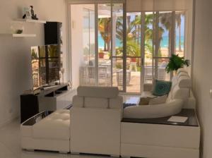 a living room with a white couch and chairs at KatlantiK Deluxe Villa in Sal Rei