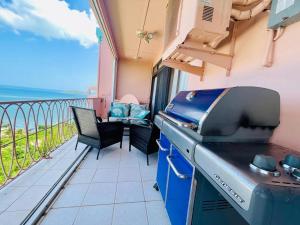 a grill on a balcony with a view of the ocean at St Croix Bliss - Tranquil Retreat-Ocean Views-Island Breezes in Christiansted