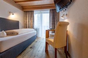 Łóżko lub łóżka w pokoju w obiekcie Hotel Seelos