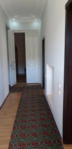 an empty hallway with a rug on the floor at Mero House in Kutaisi