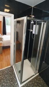 a sliding glass door in a room with a bedroom at Midway Guest House in Torquay