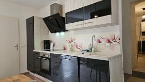 a kitchen with pink flowers on the wall at APARTMENTS KREMSTAL in Imbach