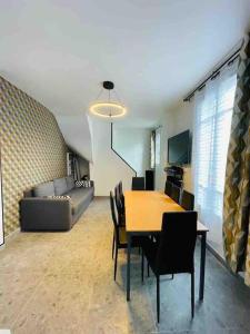 ein Wohnzimmer mit einem Tisch und einem Sofa in der Unterkunft Apartment Secret room Paris-Stade de France in Aubervilliers