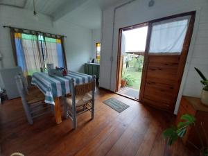 a room with a table and chairs and a door at Las Nativas de Areco in San Antonio de Areco