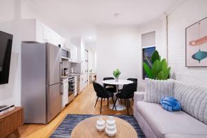 a living room with a couch and a table at 1290-8 New Renovated 2 Bedrooms in UES in New York