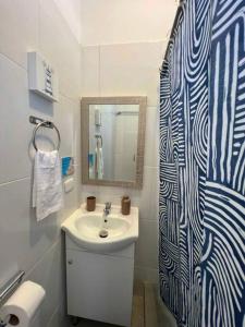 a bathroom with a sink and a mirror at Departamento en Primera Fila 306 in Zorritos