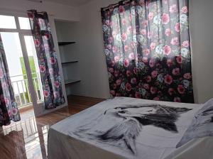 a bedroom with a bed with a drawing of a woman at villas andrez in Savinia