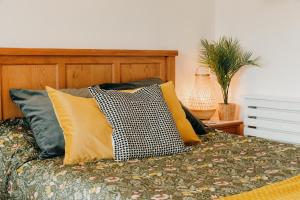 un letto con molti cuscini sopra di Luxury Private Suite-Parking, Courtyard & Wi-Fi a Caldicot