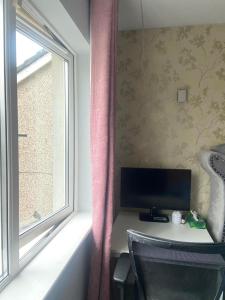 a room with a desk with a computer and a window at Private shared room near Blanchardstown shopping center 