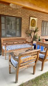 two wooden benches sitting on a patio at Bangalô Amarelo in Prado