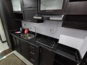 a small kitchen with a sink and a microwave at Cecelia resort in Hurghada