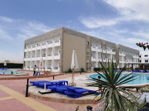 a hotel with a swimming pool and a building at Cecelia resort in Hurghada