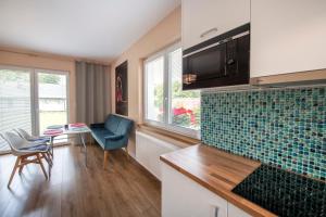 Telewizja i/lub zestaw kina domowego w obiekcie Apartamenty Mozaika - centrum Zdroju