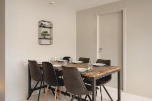 a dining room with a wooden table and chairs at Arctic Homes - Premium Penthouse in Tromsø