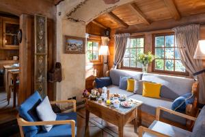 a living room with a couch and a table at Au Coin Du Feu in Megève