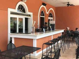 a bar in a restaurant with tables and chairs at Beautiful 4 Bedroom Vacation Home at Regal Palms Resort, close to Disney World in Davenport