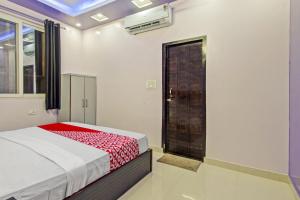 1 dormitorio con cama, ventana y puerta en Hotel Krishna Palace, en Jaipur