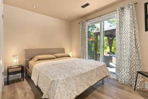 a bedroom with a bed and a large window at Deer Den cottage in Huntsville in Huntsville