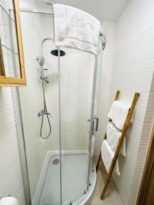 a bathroom with a shower with a glass door at Closer Place in Tomaszów Mazowiecki +25 photos