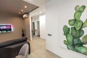 a living room with a cactus mural on the wall at Cactus Apartments 2 in Ivano-Frankivsk