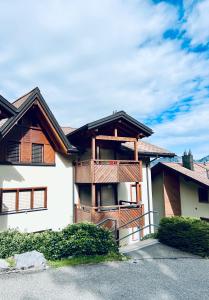 a house with a balcony on the side of it at Alpenresidenz - CharmingStay in Flumserberg