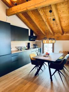 a kitchen and dining room with a table and chairs at Alpenresidenz - CharmingStay in Flumserberg