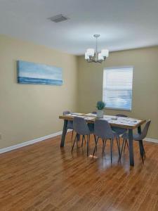 a dining room with a table and chairs in a room at WALK TO BEACH: 3BR home with spacious backyard in Jacksonville Beach